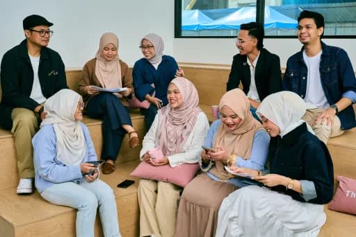 Team members talking on the lounge sofa
