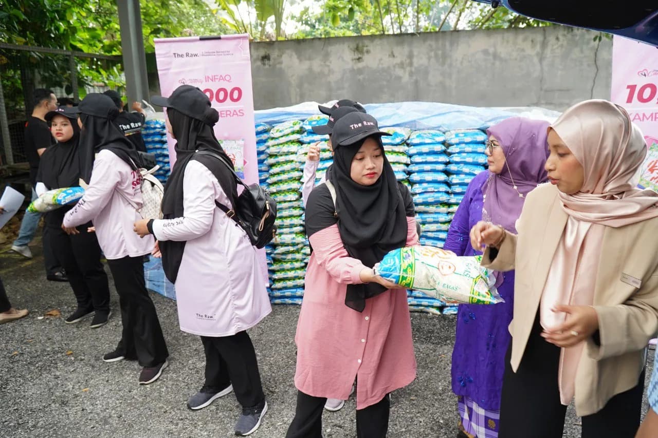 The Raw team and community members at the rice donation event
